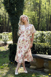 a lady in a pink floral printed dress